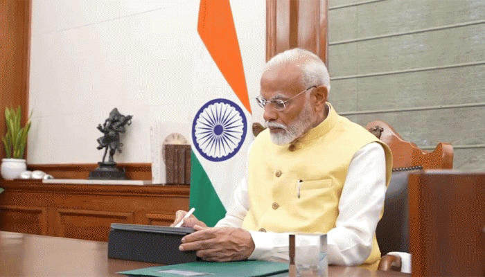 PM Modi takes office and signs the first document pertaining to the PM Kisan Nidhi money release.